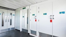 a communal fire doorset and a service room fire doorset in a multi-occupied residential corridor, ensuring fire safety compliance