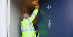 Technician carrying out a fire doorset inspection