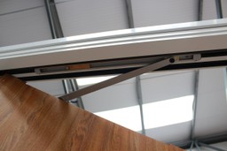 Intumescent strips on a fire door expand under heat to seal gaps and prevent smoke spread.