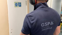 Certified installer fitting a residential fire door for compliance and safety.