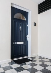 A sleek contemporary fire door installed in a modern residential flat.